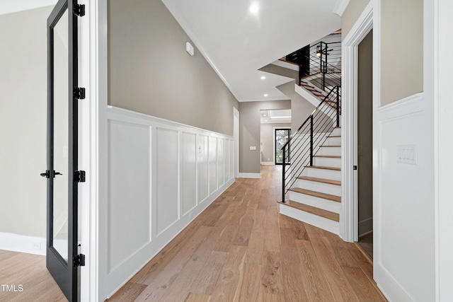 5406 Garrett Rd, Durham, NC 27707 - corridor with a decorative wall, light wood-style floors, stairway, wainscoting, and ornamental molding