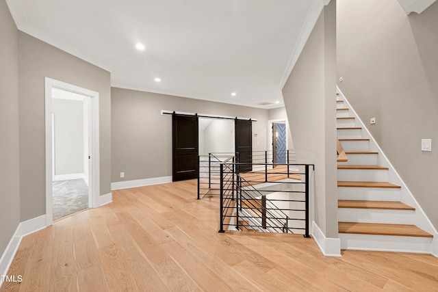 5406 Garrett Rd, Durham, NC 27707 - unfurnished room with a barn door, light wood-type flooring, recessed lighting, and crown molding