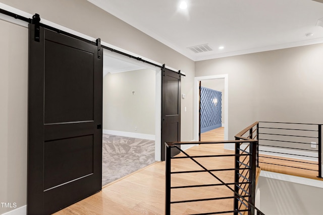 5406 Garrett Rd, Durham, NC 27707 - stairway featuring a barn door, wood finished floors, crown molding, and recessed lighting