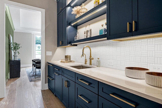 5406 Garrett Rd, Durham, NC 27707 - kitchen with blue cabinets, tasteful backsplash, wood finished floors, and open shelves