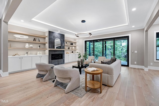 5406 Garrett Rd, Durham, NC 27707 - living room featuring a raised ceiling, light wood-style floors, a fireplace, built in shelves, and recessed lighting