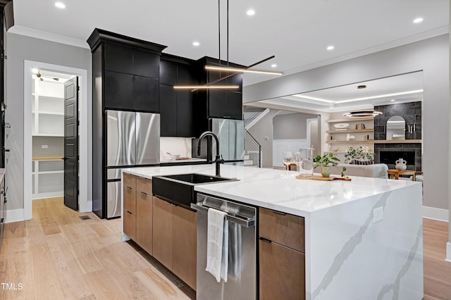 5406 Garrett Rd, Durham, NC 27707 - kitchen with appliances with stainless steel finishes, dark cabinetry, a large island, modern cabinets, and crown molding