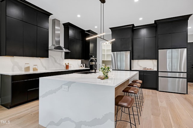 5406 Garrett Rd, Durham, NC 27707 - kitchen with dark cabinets, freestanding refrigerator, wall chimney range hood, pendant lighting, and recessed lighting