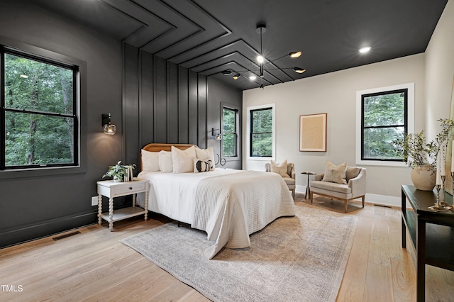 5406 Garrett Rd, Durham, NC 27707 - bedroom with light wood finished floors and a chandelier