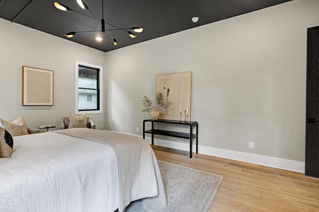 5406 Garrett Rd, Durham, NC 27707 - bedroom featuring wood finished floors and a chandelier