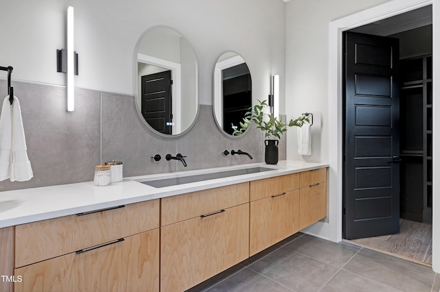 5406 Garrett Rd, Durham, NC 27707 - bathroom featuring double vanity, tile patterned floors, and backsplash