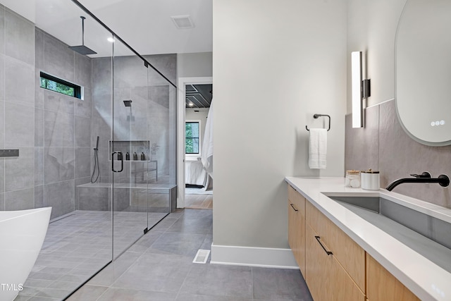 5406 Garrett Rd, Durham, NC 27707 - full bathroom featuring vanity, a stall shower, tile patterned floors, and a freestanding bath