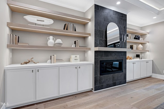 5406 Garrett Rd, Durham, NC 27707 - bar featuring ornamental molding, light wood finished floors, a tiled fireplace, and recessed lighting