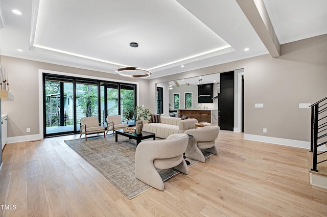 5406 Garrett Rd, Durham, NC 27707 - living area featuring a tray ceiling, light wood finished floors, recessed lighting, and a chandelier
