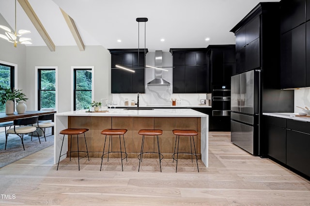 5406 Garrett Rd, Durham, NC 27707 - kitchen with dark cabinets, freestanding refrigerator, wall chimney range hood, light countertops, and beamed ceiling