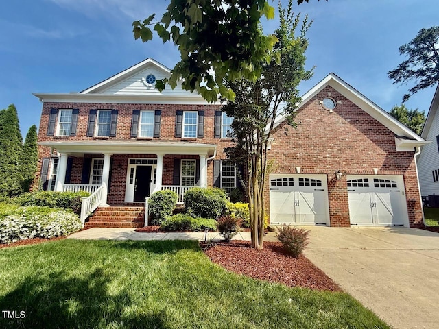 9409 Collingdale Way, Raleigh, NC 27617 - colonial inspired home with brick siding, driveway, a porch, and a garage