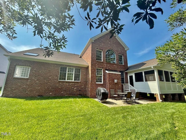 9409 Collingdale Way, Raleigh, NC 27617 - rear view of property with a patio area, brick siding, a lawn, crawl space, and a sunroom