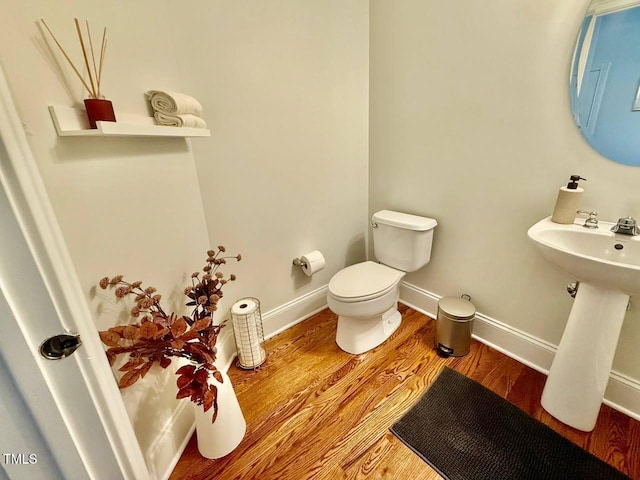 9409 Collingdale Way, Raleigh, NC 27617 - half bathroom with toilet, wood finished floors, and baseboards