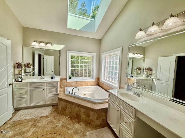 9409 Collingdale Way, Raleigh, NC 27617 - full bath featuring a skylight, a jetted tub, two vanities, and high vaulted ceiling