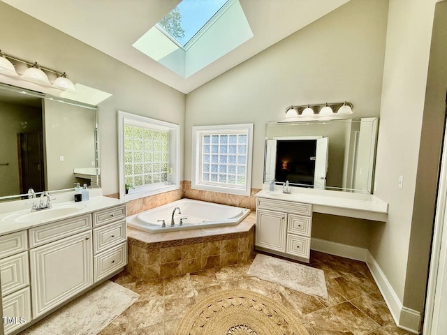 9409 Collingdale Way, Raleigh, NC 27617 - bathroom featuring a skylight, a garden tub, two vanities, high vaulted ceiling, and baseboards