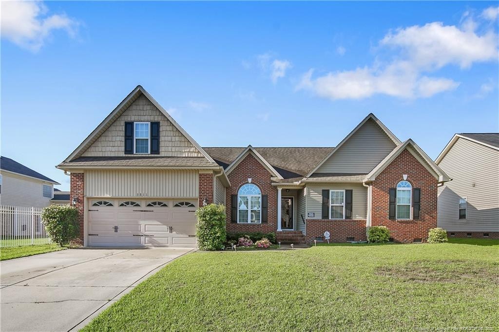 3811 Briargate Ln, Fayetteville, NC 28314 - view of front facade featuring driveway, brick siding, a garage, and crawl space