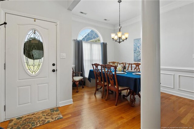 3811 Briargate Ln, Fayetteville, NC 28314 - entryway with a chandelier, light wood-style flooring, and ornamental molding
