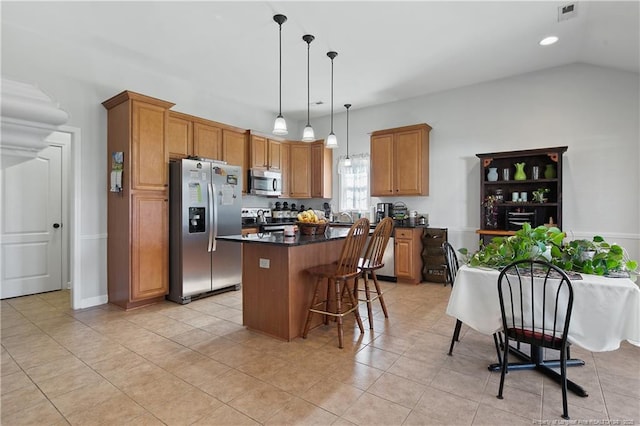 3811 Briargate Ln, Fayetteville, NC 28314 - kitchen featuring stainless steel appliances, dark countertops, a kitchen island, a kitchen breakfast bar, and decorative light fixtures