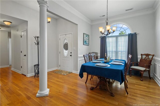 3811 Briargate Ln, Fayetteville, NC 28314 - dining room with decorative columns, a chandelier, light wood-style flooring, and crown molding