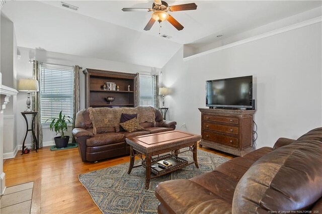 3811 Briargate Ln, Fayetteville, NC 28314 - living area with ceiling fan, light wood finished floors, vaulted ceiling, a fireplace, and baseboards