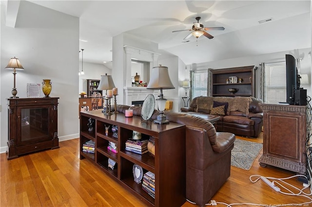 3811 Briargate Ln, Fayetteville, NC 28314 - living room featuring ceiling fan, light wood-type flooring, baseboards, and a fireplace