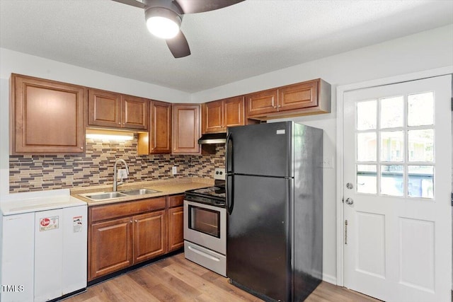 1512 Bacon St, Durham, NC 27701 - kitchen with freestanding refrigerator, stainless steel electric stove, a sink, under cabinet range hood, and ceiling fan