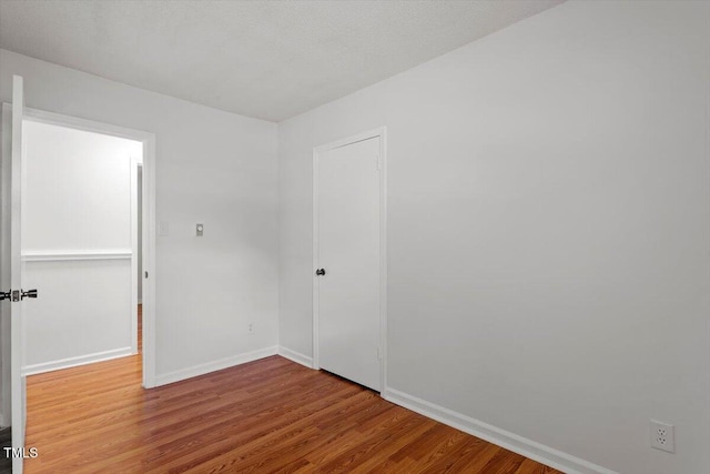1512 Bacon St, Durham, NC 27701 - spare room featuring wood finished floors and baseboards