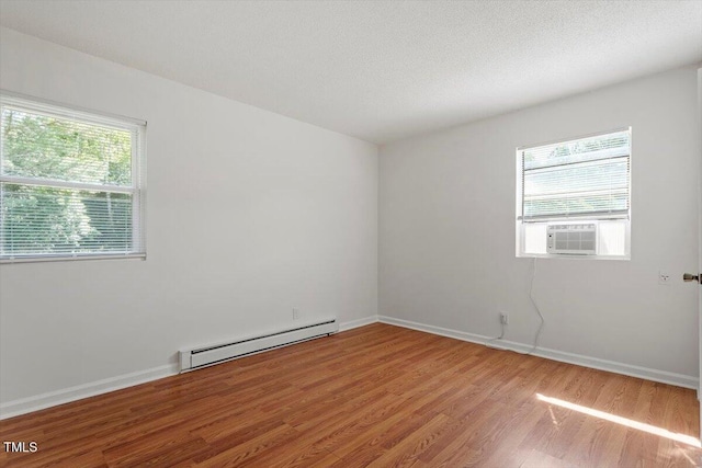 1512 Bacon St, Durham, NC 27701 - empty room with baseboard heating, wood finished floors, cooling unit, and baseboards