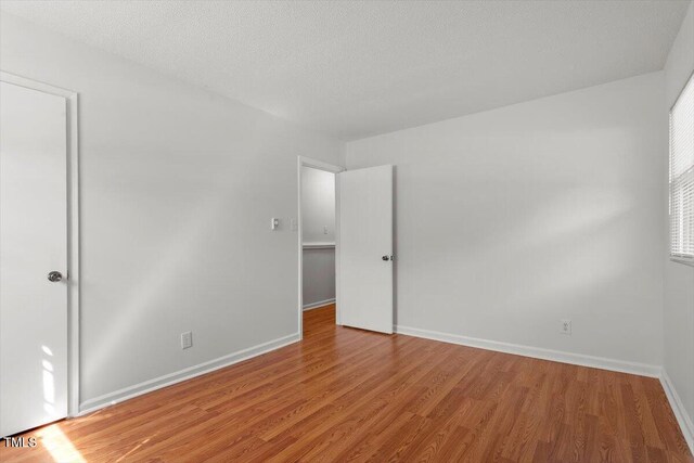 1512 Bacon St, Durham, NC 27701 - spare room with light wood-style floors and baseboards