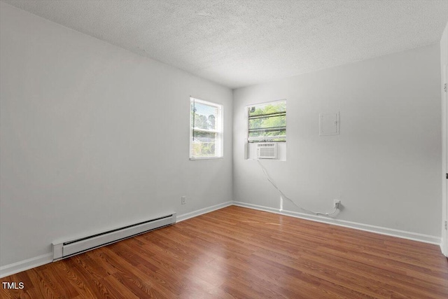 1512 Bacon St, Durham, NC 27701 - unfurnished room with a baseboard heating unit, wood finished floors, cooling unit, baseboards, and a textured ceiling