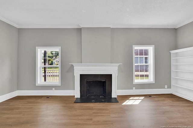 201 N College St, Red Springs, NC 28377 - unfurnished living room featuring wood finished floors, ornamental molding, baseboards, a fireplace, and a textured ceiling