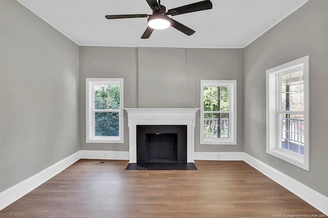 201 N College St, Red Springs, NC 28377 - unfurnished living room featuring plenty of natural light, wood finished floors, ornamental molding, a ceiling fan, and baseboards