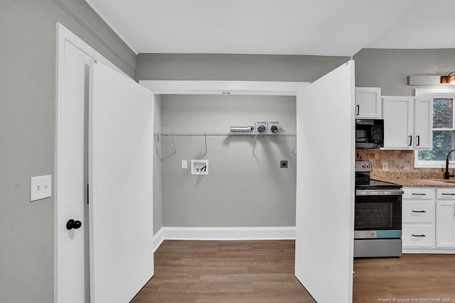201 N College St, Red Springs, NC 28377 - laundry room featuring washer hookup, electric dryer hookup, wood finished floors, and baseboards
