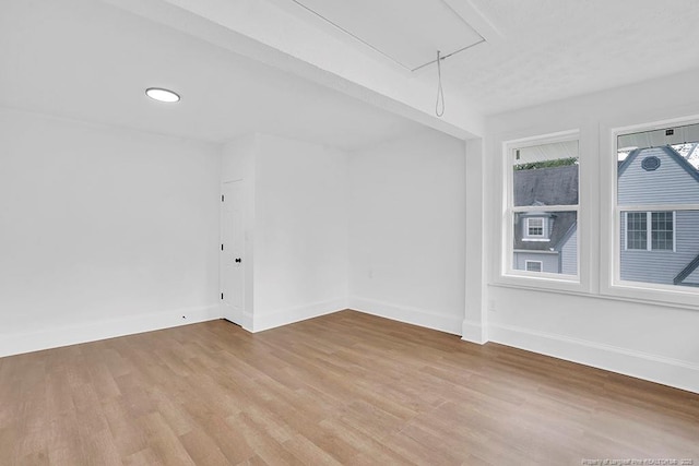 201 N College St, Red Springs, NC 28377 - unfurnished room with attic access, light wood-type flooring, and baseboards