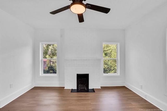 201 N College St, Red Springs, NC 28377 - unfurnished living room featuring a fireplace, a ceiling fan, wood finished floors, and baseboards