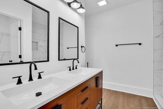 201 N College St, Red Springs, NC 28377 - bathroom featuring double vanity, wood finished floors, and baseboards