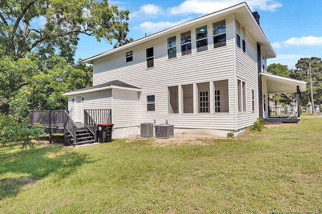 201 N College St, Red Springs, NC 28377 - back of house featuring a chimney, a lawn, cooling unit, and a wooden deck