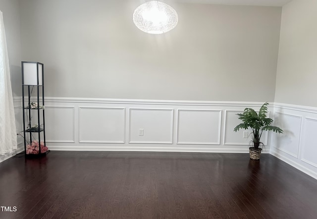 1116 Powder, Fuquay Varina, NC 27526 - empty room featuring a decorative wall, dark wood-style floors, a chandelier, and a wainscoted wall