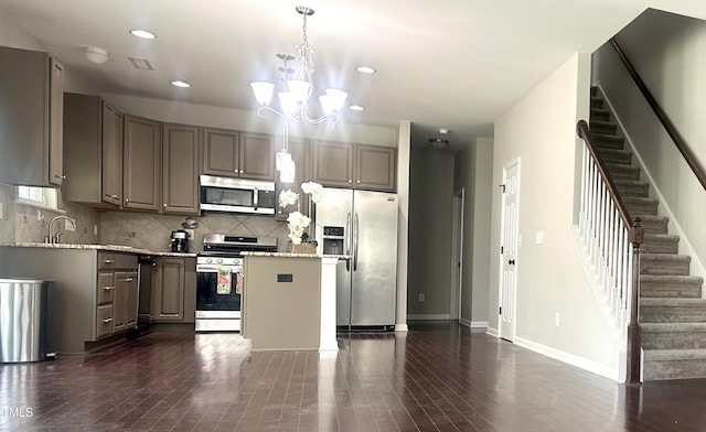 1116 Powder, Fuquay Varina, NC 27526 - kitchen featuring appliances with stainless steel finishes, gray cabinetry, recessed lighting, tasteful backsplash, and a chandelier