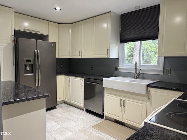 507 Holtz Ln, Cary, NC 27511 - kitchen featuring appliances with stainless steel finishes, a sink, light tile patterned floors, dark stone countertops, and recessed lighting