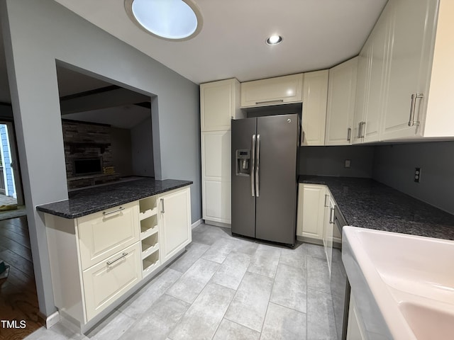 507 Holtz Ln, Cary, NC 27511 - kitchen with stainless steel refrigerator with ice dispenser, white cabinetry, dark stone countertops, and recessed lighting