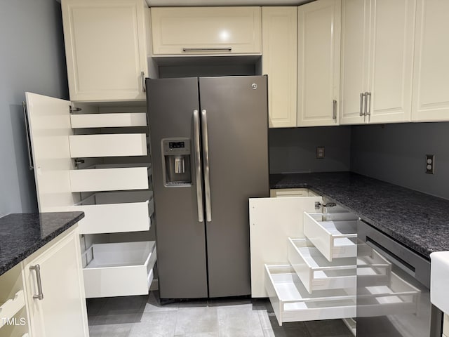 507 Holtz Ln, Cary, NC 27511 - kitchen with stainless steel fridge, dark stone countertops, light tile patterned flooring, and white cabinets