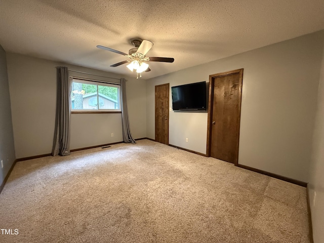 507 Holtz Ln, Cary, NC 27511 - unfurnished bedroom with light carpet, baseboards, a textured ceiling, and ceiling fan