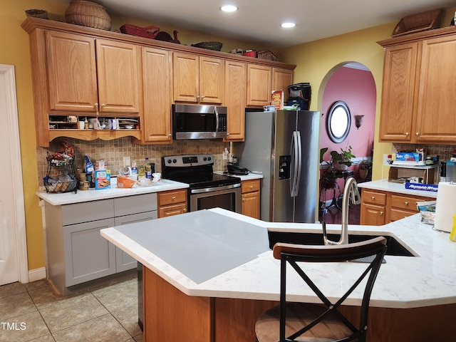18 Clover Hil Pl, Durham, NC 27712 - kitchen with appliances with stainless steel finishes, decorative backsplash, arched walkways, recessed lighting, and light tile patterned flooring