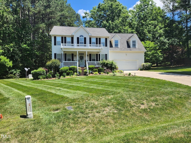 18 Clover Hil Pl, Durham, NC 27712 - colonial-style house with covered porch, concrete driveway, a garage, a front lawn, and a balcony