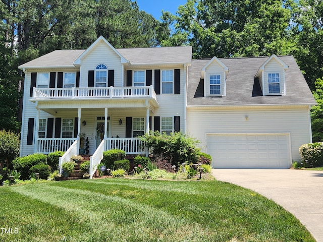 18 Clover Hil Pl, Durham, NC 27712 - colonial home featuring a porch, concrete driveway, a front yard, an attached garage, and a balcony