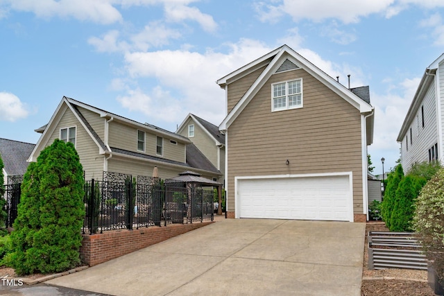 321 Commons Walk Cir, Cary, NC 27519 - view of side of property with a gazebo, a garage, and concrete driveway