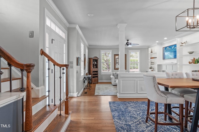 321 Commons Walk Cir, Cary, NC 27519 - dining area featuring crown molding, wood finished floors, stairway, baseboards, and a chandelier