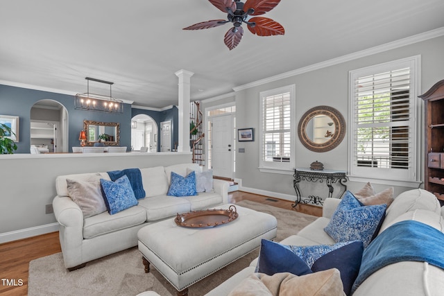 321 Commons Walk Cir, Cary, NC 27519 - living room featuring arched walkways, ceiling fan, wood finished floors, ornamental molding, and baseboards