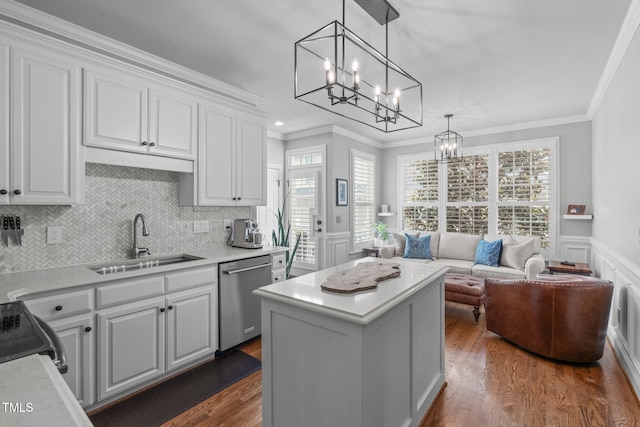 321 Commons Walk Cir, Cary, NC 27519 - kitchen featuring stainless steel dishwasher, a sink, a chandelier, crown molding, and white cabinetry